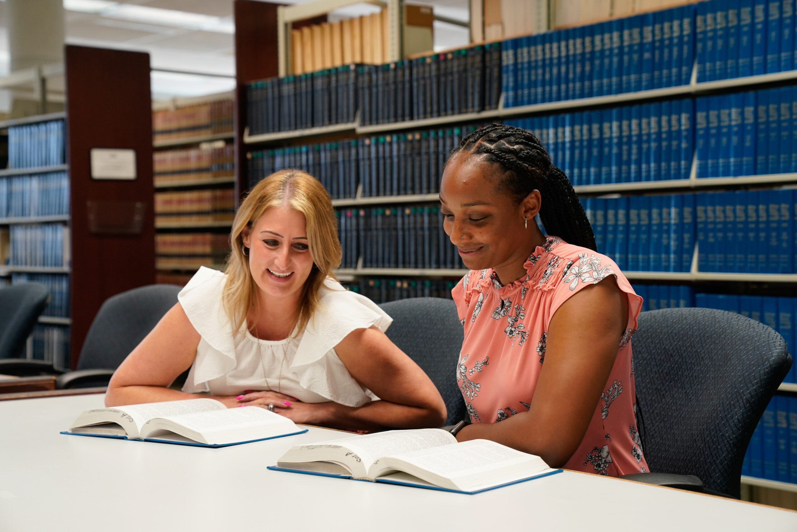 Two female law students study together in the Law Library.